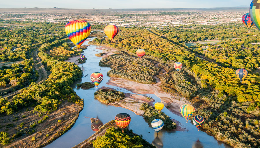 View of colorful hot air balloons over the Rio Grande