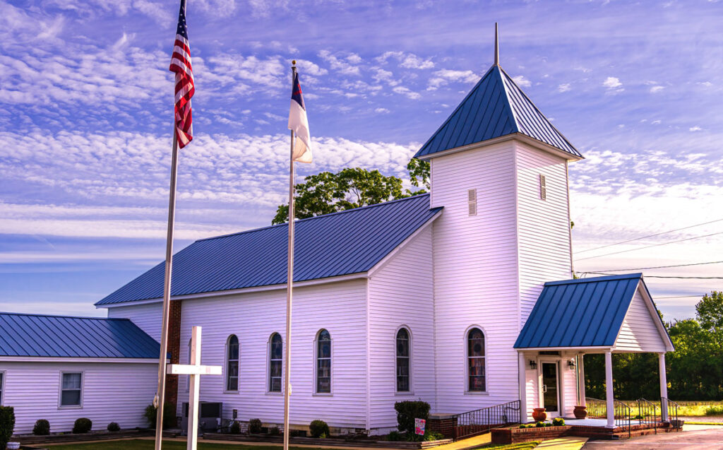 View of an Evangelical Church with the United States flag on the pole, and a clear blue sky