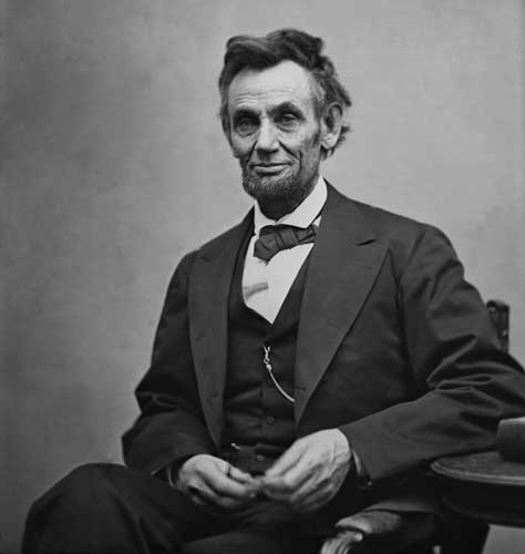 A photo of Abraham Lincoln smiling while seating