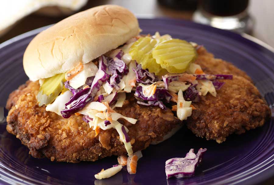 Close up view of a Pork Tenderloin Sandwich on a plate