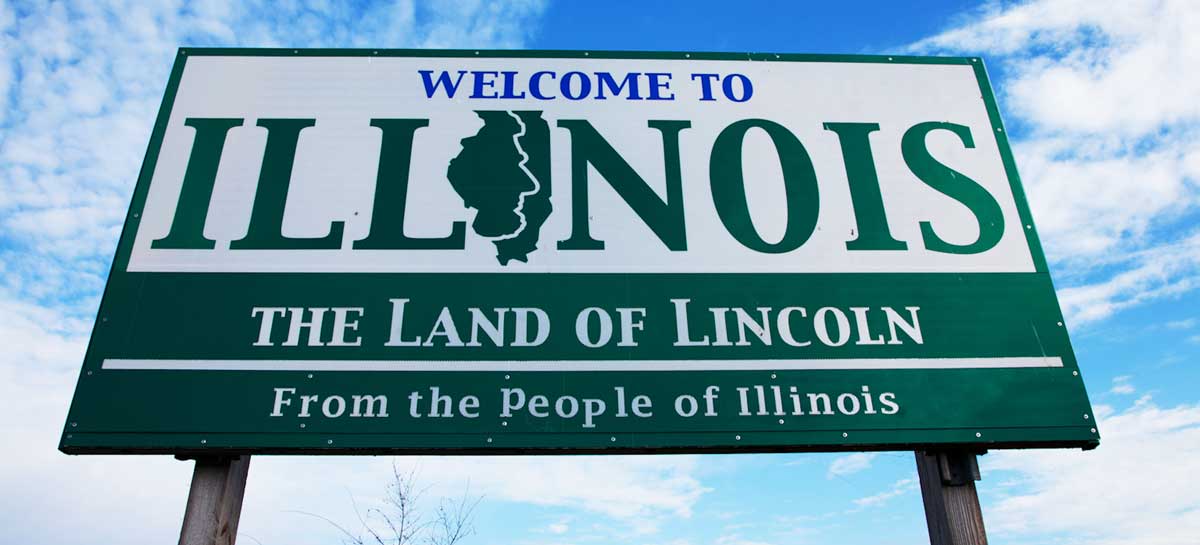 A welcome sign under the clear blue sky in Illinois reading "The Land of Lincoln," one of the things Illinois is known for