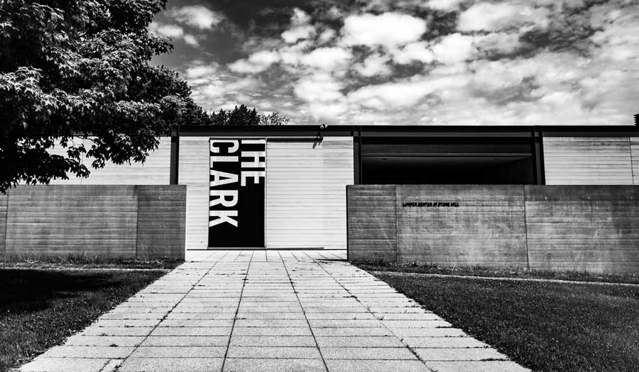 A black and white photo of the Clark Art Institute from the outside