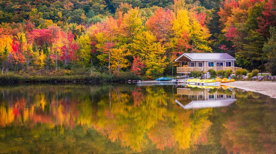 Reflection of a boathouse on Echo Lake during fall season