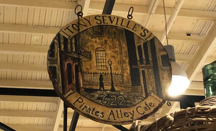 The sign of Pirates Alley Cafe hanging at the New Orleans French Quarter