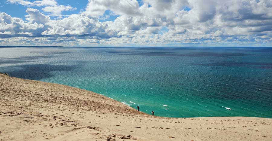 Two people climbing the dunes in Sleeping Bear Dunes National Lakeshore