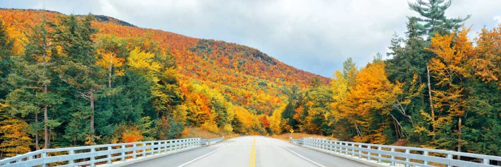 View from a highway in New Hampshire and the White Mountains during autumn season, one of the things New Hampshire is known for