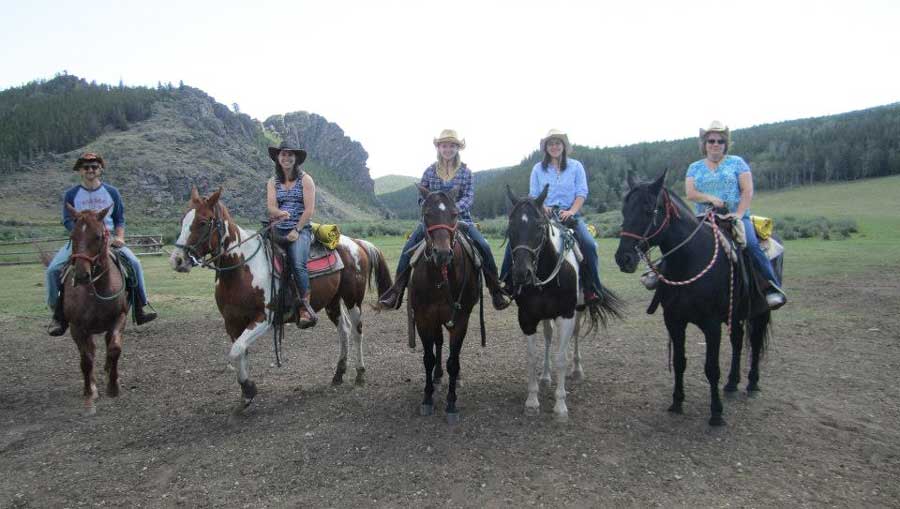 People horseback riding in Wyoming