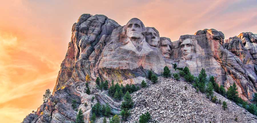 The Mount Rushmore National Memorial under the colorful sky during sunset
