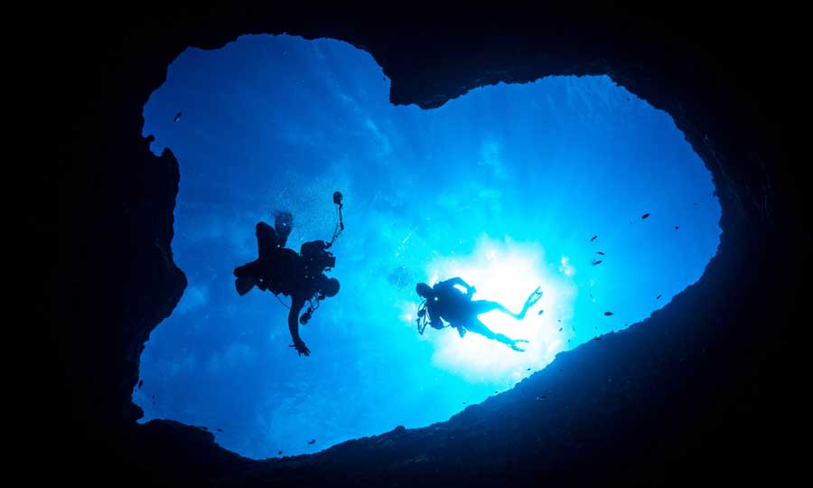 View of two people swimming in at the Blue Hole in Guam