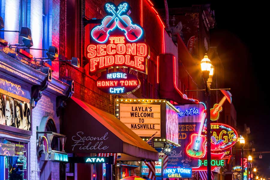 Neon signs of music clubs in downtown Nashville at night