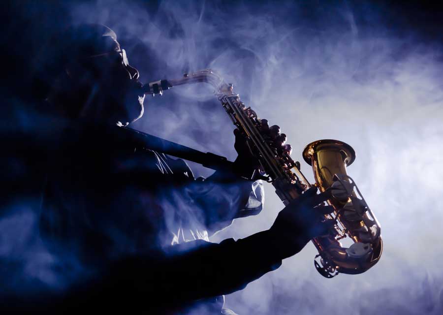 A man playing his saxophone