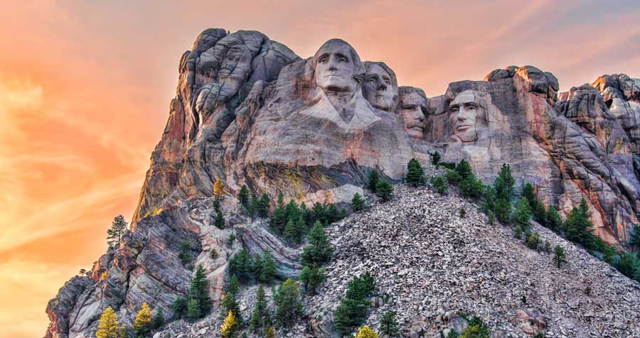 Mount Rushmore under the colorful sky during sunset