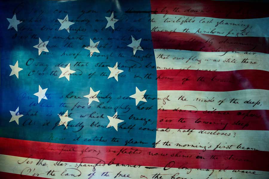 The Star-Spangled Banner written on the flag of America