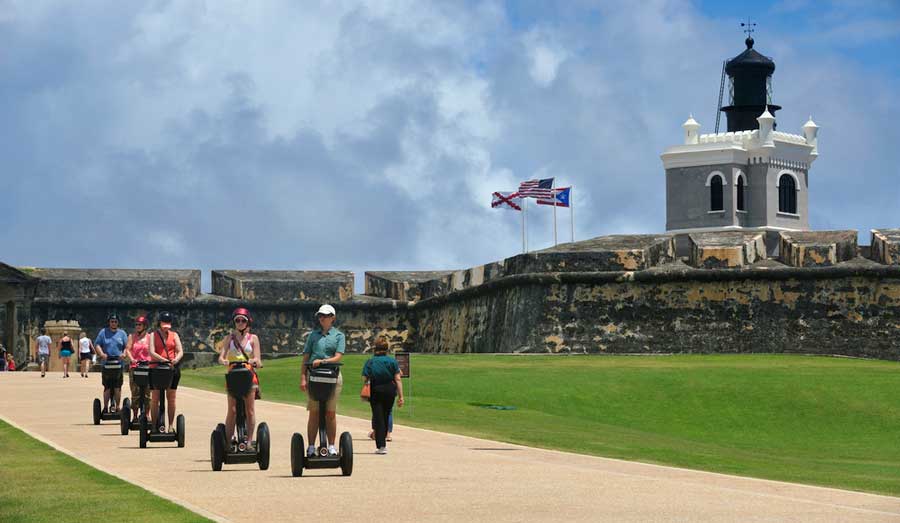 View of tourists riding a self balancing scooter in Castillo San Felipe del Morro